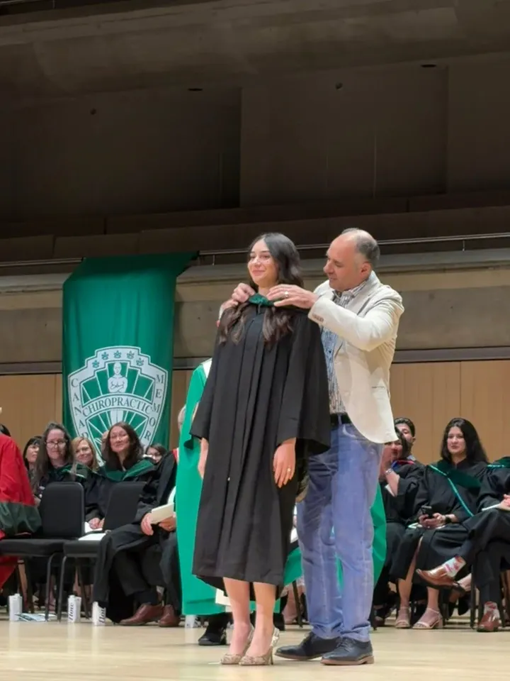 Dr. Alexandria Abbruzzino receiving her chiropractic hood at her CMCC graduation
